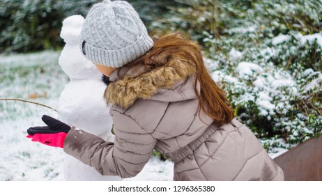 Girls Building Snowman. Kids Build Snow Man. Girls Playing Outdoors On Snowy Winter Day. Christmas Vacation.