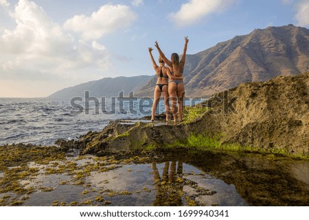 Girls Cheering at Sunset on a Beach in Hawaii