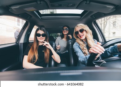 Girls Driving In A Convertible Car And Having Fun