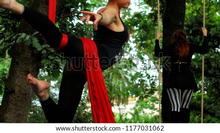 Girls exhibiting in a show of aerial dance in the botanical garden of Naples