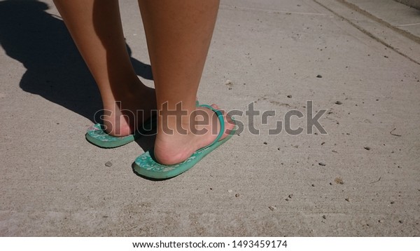 Girls Feet On Flip Flops Standing Stock Photo (Edit Now) 1493459174