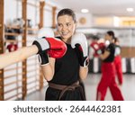 Girls are fighting at moment of contact in boxing match. Active training, practicing skills of defeating opponent in ring, boxing school for amateurs and professionals................