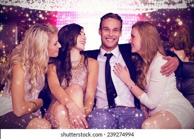 Girls Flirting With Young Man Against Gold And Red Lights