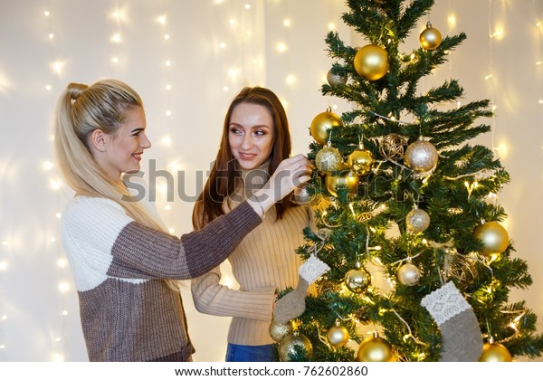 Girls Friends Decorating Furtree Near Fireplace Stock Photo Edit