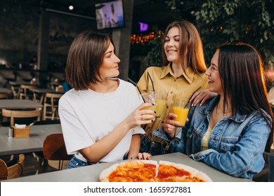 Girls Friends Having Pizza At A Bar At A Lunch Time