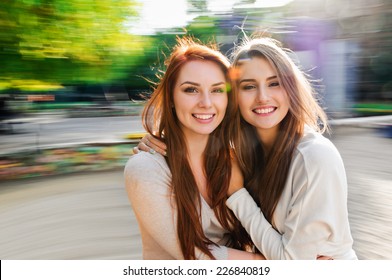 Girls Friends Laughing And Outdoor On The Carousel