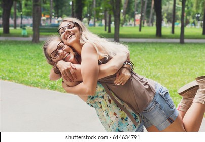 Girls Friendship. Happy Boho Females Hug Each Other, Friends Embrace. Summer Walk In The Park Outdoors