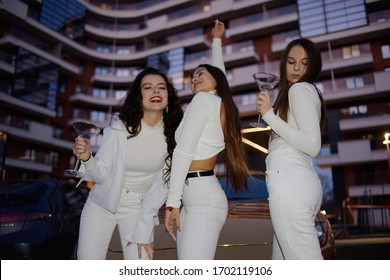 Girls, Girlfriends Having Fun Near The Golden Car. Girls All In White, At A Bachelorette Party Celebrate