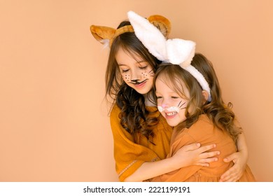 Girls in the guise of a rabbit and a tiger are symbols of the outgoing old year 2022 and the new year 2022. Children with animal makeup with hats with ears. - Shutterstock ID 2221199191