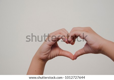 Girl's hand forming heart. Composition of love.