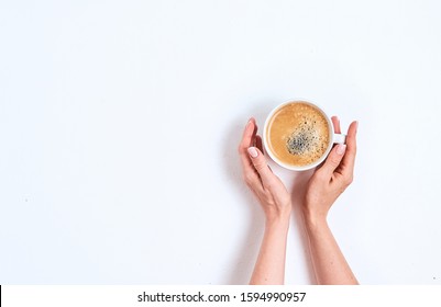 Girl's Hand Holding Coffee Cup On White Background, Flat Lay, Top View