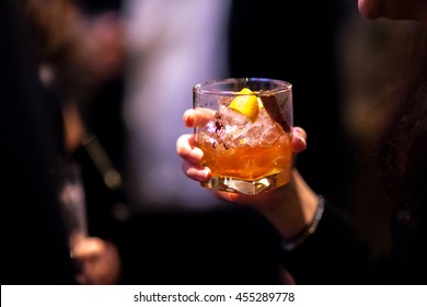 Girls Hand On Glass Of Whisky Cocktail