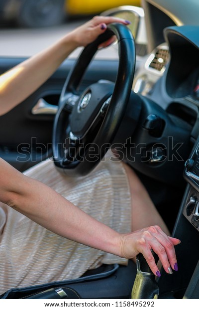 Girl\'s hand on a stearing\
wheel