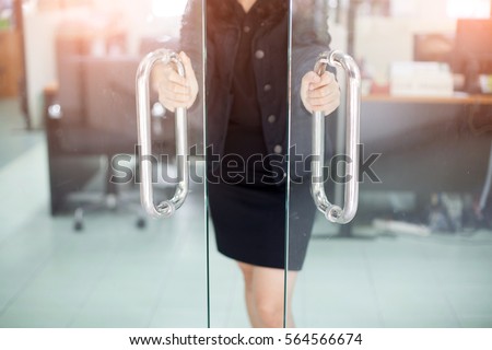 Girl's hand open the door with glass reflection background