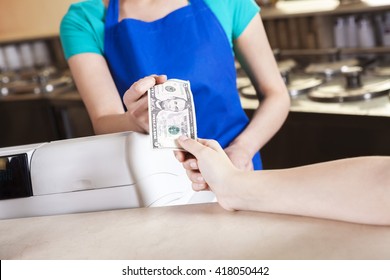 Girl's Hand Paying Money To Worker In Ice Cream Parlor - Powered by Shutterstock