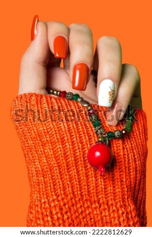 A girl's hand with Pomegranate neckless in her hand