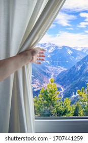 Girl's Hand Pulling Back The Curtain To See The Mountains In The Window. Concept Of Travel.