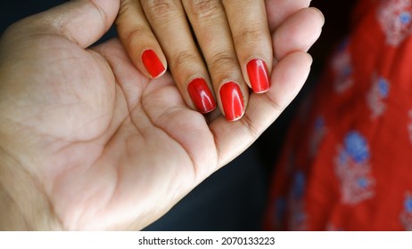 Girl's Hand With Red Nail Polish On Nails Keeps On Boy's Hand.