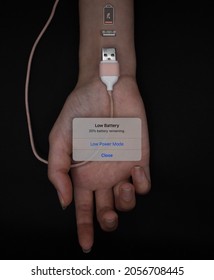 A Girl's Hand Is Stretched Out Over A Charging Cable With An Empty Battery Sign And A Window Like The One On A Phone That Says The Battery Is Empty, Low Battery Symbol Drawn On Bionic Human Hand.