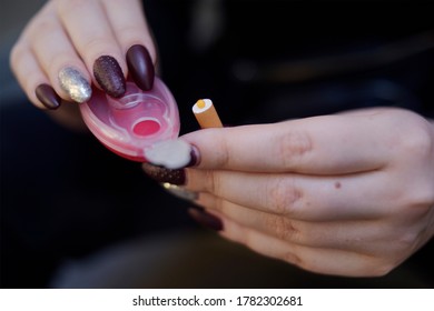 The Girl's Hands Hold Capsules For Cigarettes And Puts Them Into Cigarettes. Banning Flavored Tobacco. The Girl Will Buy, Plozie Habits, Bypassing The Rules.