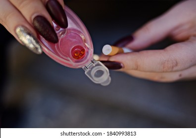 The Girl's Hands Hold Capsules For Cigarettes And Puts Them Into Cigarettes. Banning Flavored Tobacco. The Girl Will Buy, Plozie Habits, Bypassing The Rules.