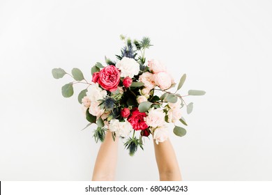 Girl's Hands Holding Beautiful Flowers Bouquet: Bombastic Roses, Blue Eringium, Eucalyptus, Isolated On White Background. Flat Lay, Top View. Floral Composition