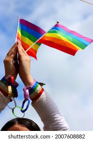 Girls Hands Holding Pride Flags At Pride Rally