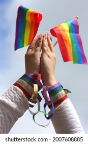 Girls Hands Holding Pride Flags At Pride Rally