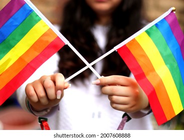 Girls Hands Holding Pride Flags At Pride Rally