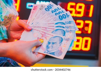 The girl's Hands holding Turkish Lira and American Dollar. Concept of the money exchange