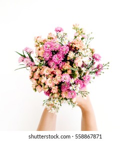 Girl's hands holding wildflowers bouquet on white background. Flat lay, top view - Powered by Shutterstock