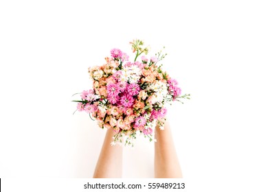 Girl's hands holding wildflowers bouquet on white background. Flat lay, top view - Powered by Shutterstock