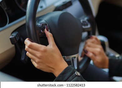 Girls hands on the steering wheel