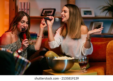 Girls Having Fun At Karaoke Night At Home.