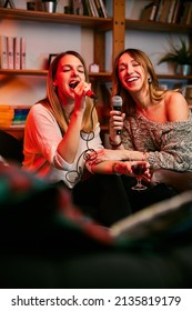 Girls Having Fun At Karaoke Night At Home.