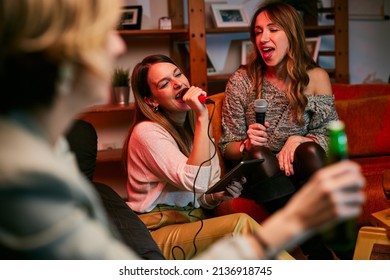 Girls Having Fun At Karaoke Night At Home.