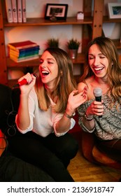 Girls Having Fun At Karaoke Night At Home.