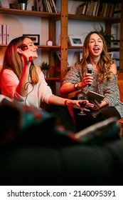 Girls Having Fun At Karaoke Night At Home.