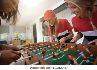 Girls Having Fun Playing Foosball At Home