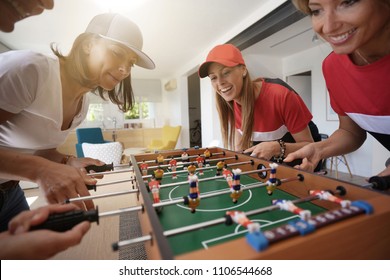 Girls Having Fun Playing Foosball At Home