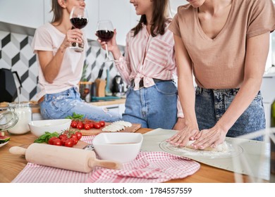 Girls having good time with homemade pizza and wine - Powered by Shutterstock