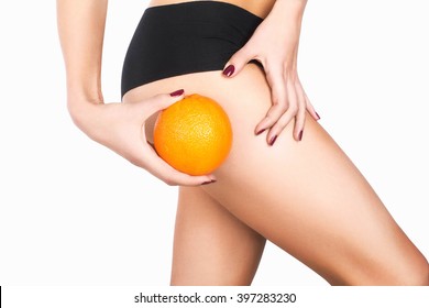 Girl's hip and an orange. Anti-cellulite program - Powered by Shutterstock