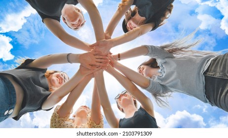 The girls join their hands against the backdrop of a beautiful sky. - Powered by Shutterstock