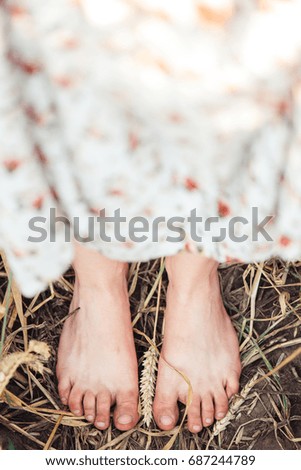 The girl's legs behind wild grass. Field trip