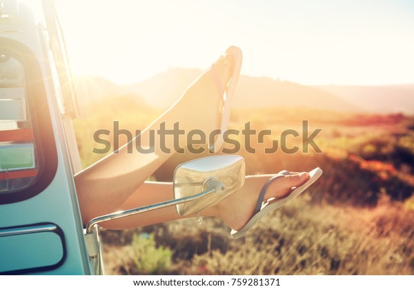 girl\'s legs\
in a retro car  at sunset, retro\
style.
