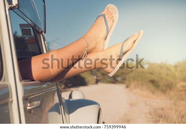 girl\'s legs\
in a retro car  at sunset, retro\
style.