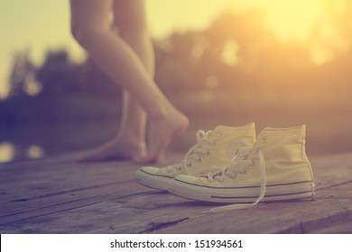 The girl's legs and sneakers - Powered by Shutterstock