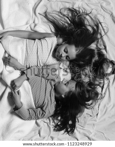 Similar – Image, Stock Photo Relaxed mother and sons embracing lying in the bed