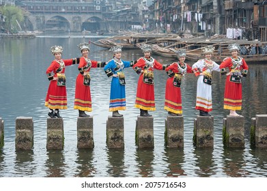 Girls in Miao Nationality Clothes Posing for Photo in Ancient Town of Fenghuang, Xiangxi Tujia and Miao Autonomous Prefecture, Hunan Province, China in March 2016