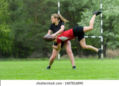 Girls Playing American Football Together Outside In Summer